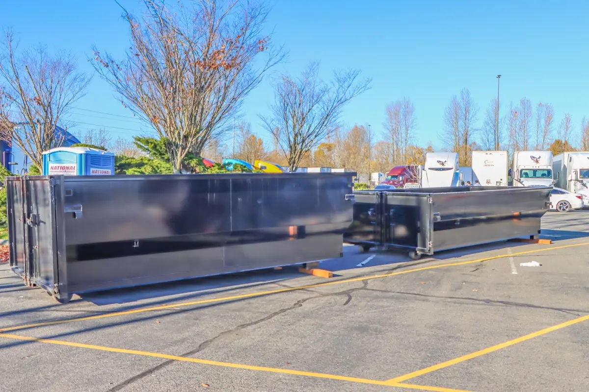 Professional dumpster rental service with roll-off container on residential driveway in Port Charlotte